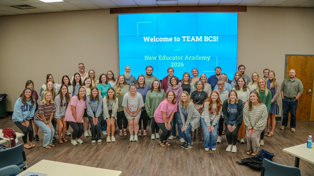 New teachers in front of screen.
