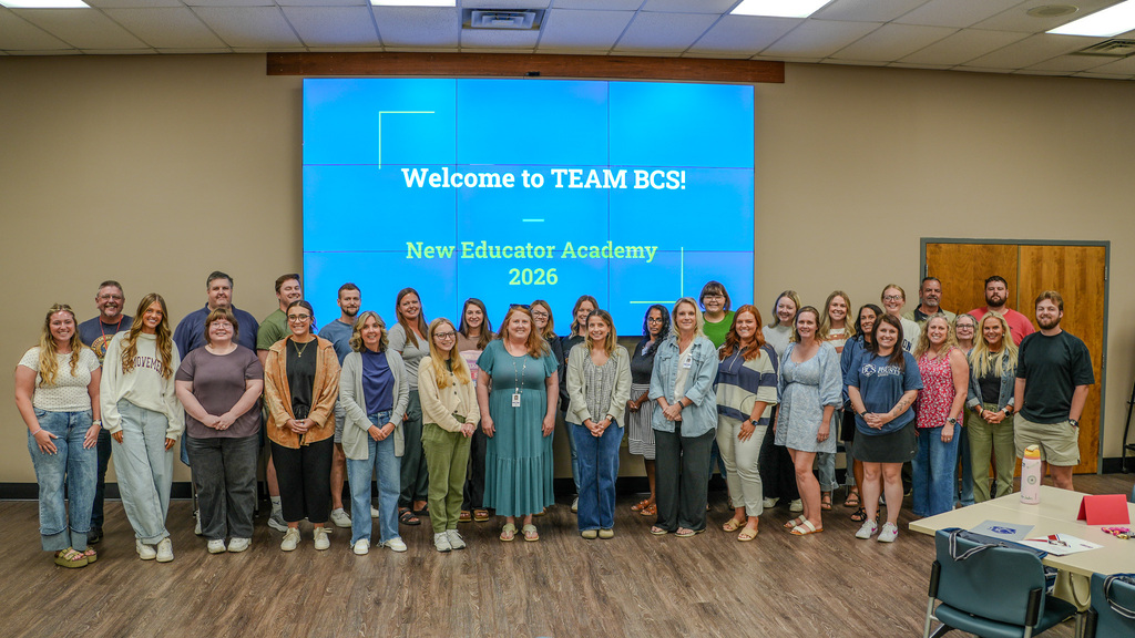 New teachers in front of screen.