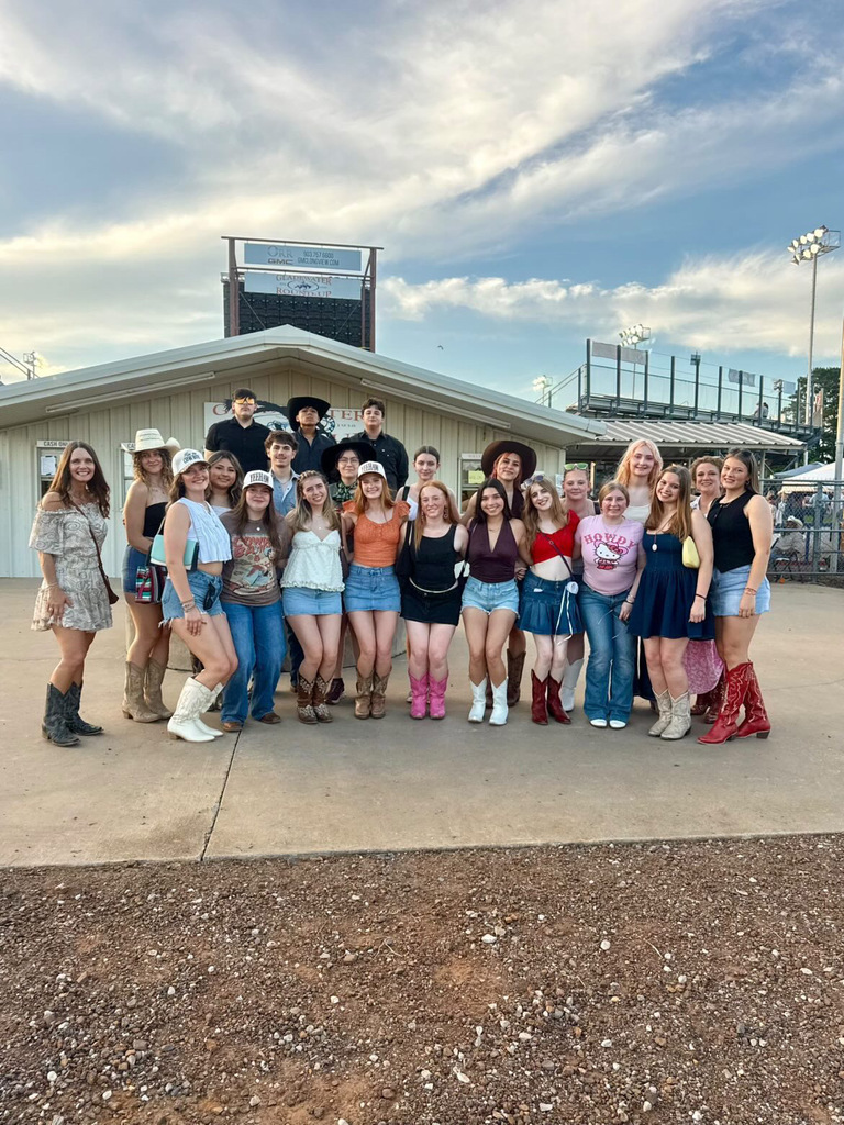 A group of students in front of a store