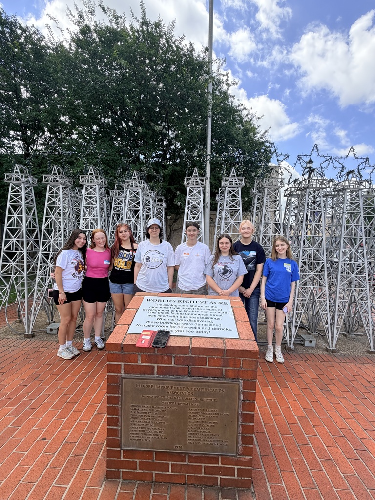 A group of students in front of towers.