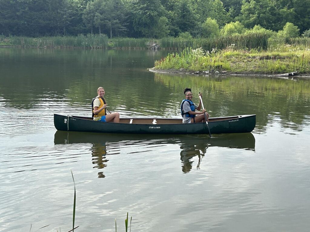 Two student in a canoe.