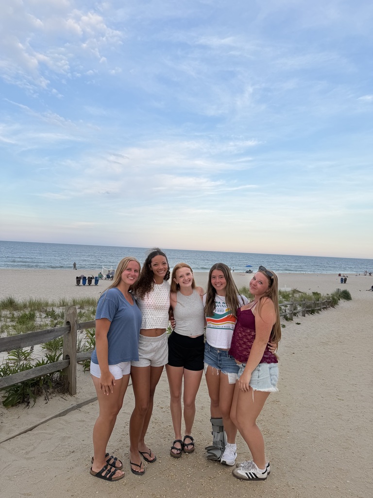 Five girls standing at the entrance to the beach.