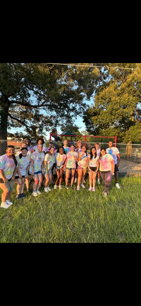 A group of students all in tie dyed shirts
