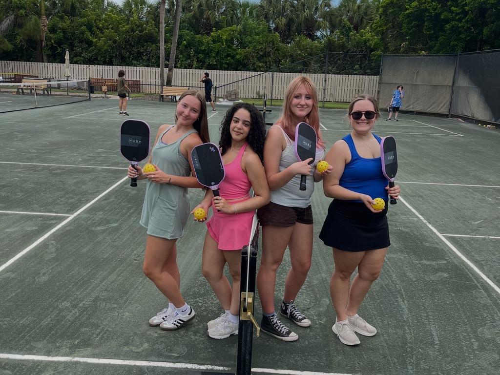 Four girls playing pickleball