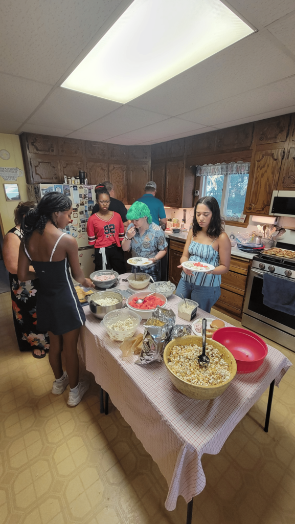 Students at the potluck trying different foods
