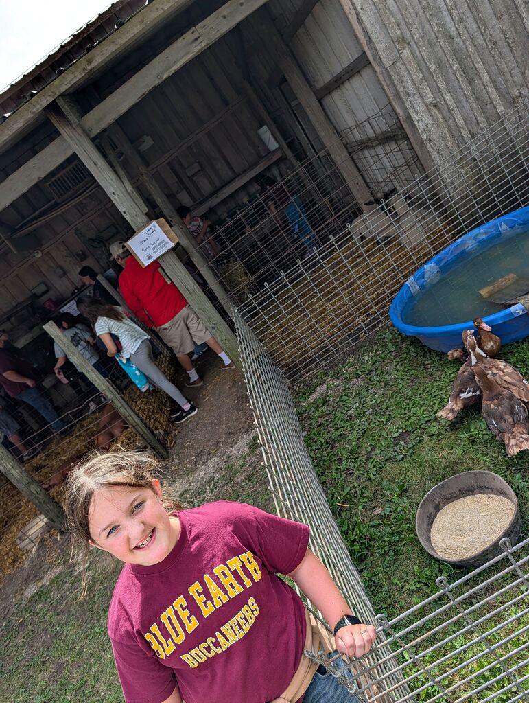 A student in front of some chickens