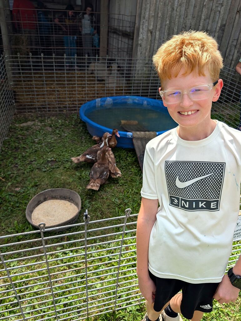A student in front of some chickens