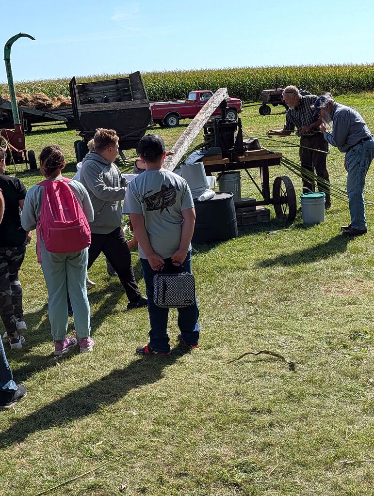 Students pushing a wood beam