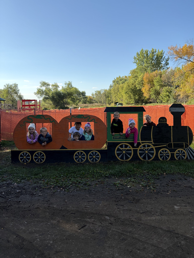 Student posing in a train with cut out windows