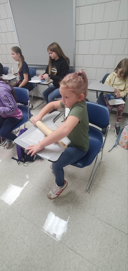 Student rolling out play-doh