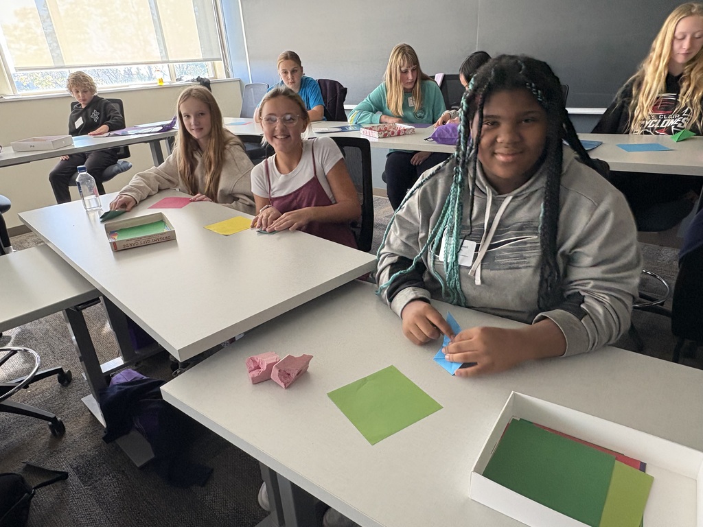 A group of students folding paper