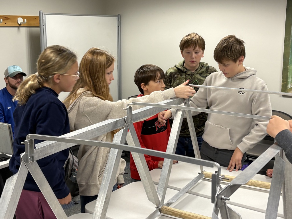 Five students building a bridge