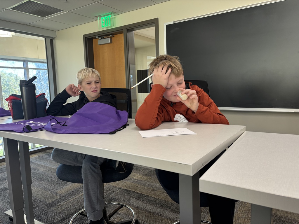 Two students smelling different substances