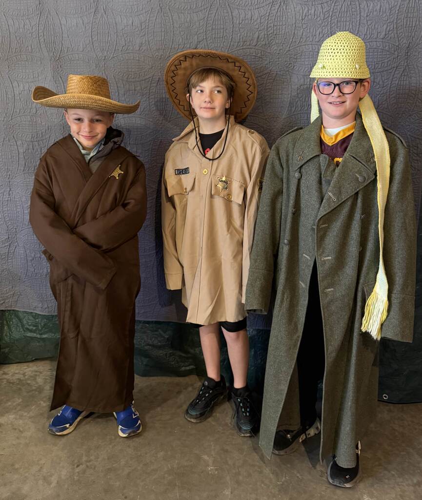 Three boys dressed up in period clothing