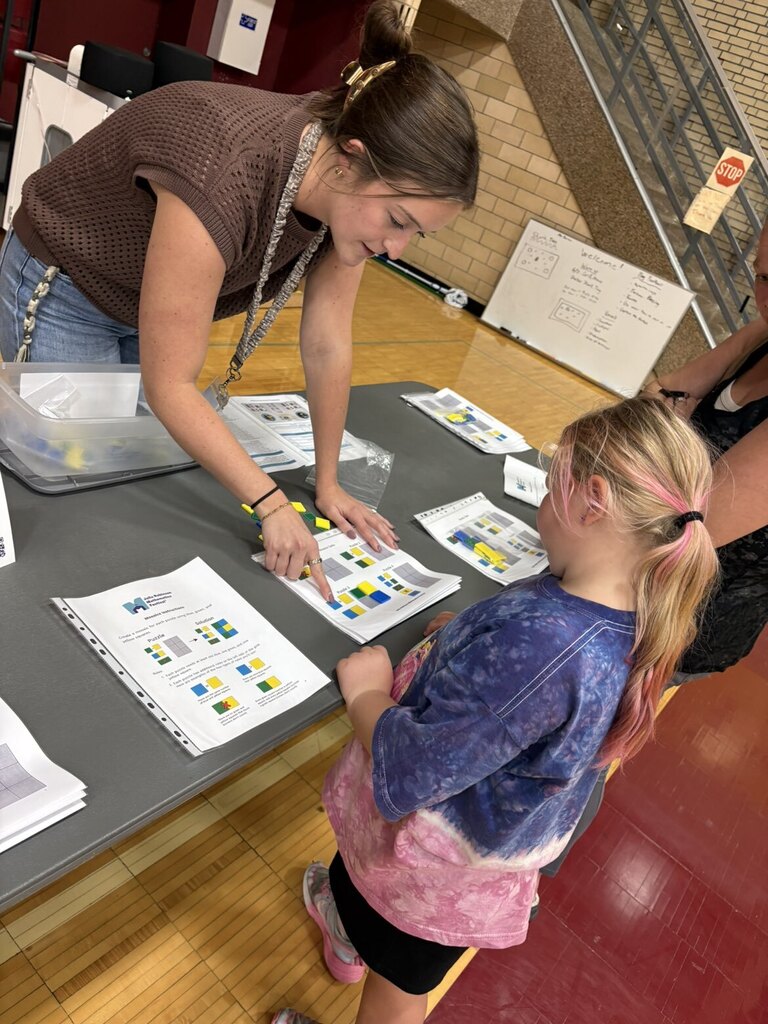 A mom and daughter playing a math game with a high school math teacher