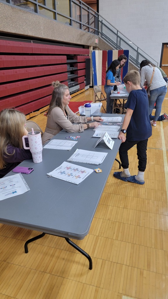 A kids playing a math game with the Superintendent