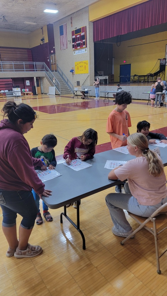A high schoolers playing a math game with younger kids