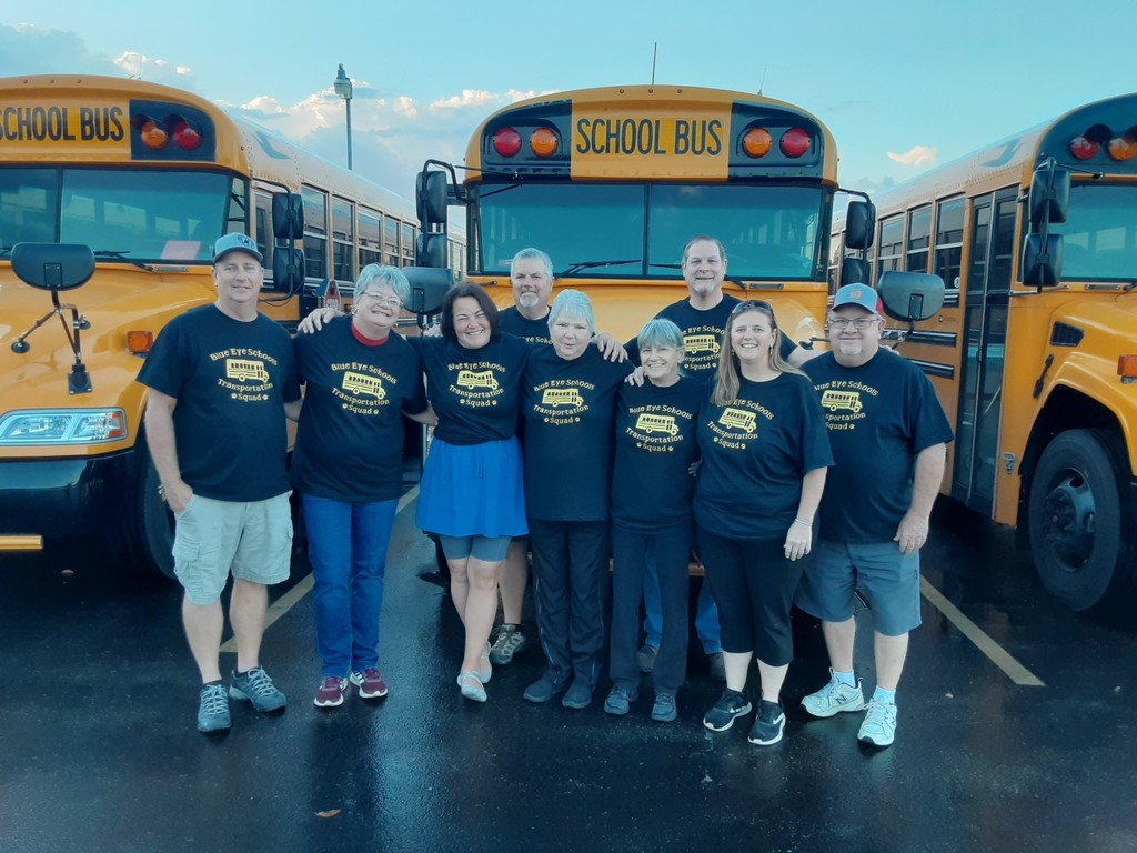 Bus Drivers group picture in front of buses.