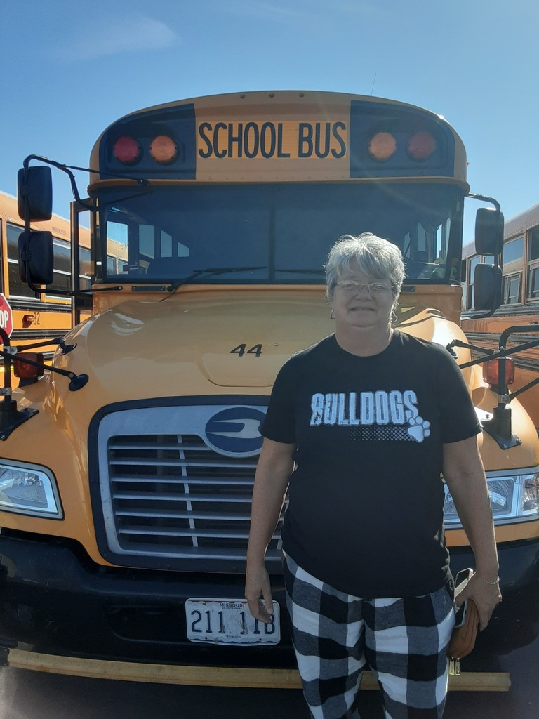 Driver in front of buses.