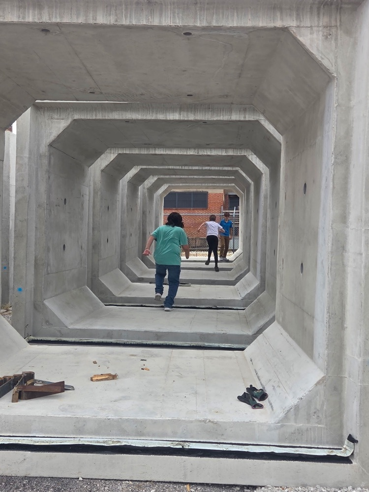 students walking on construction site.