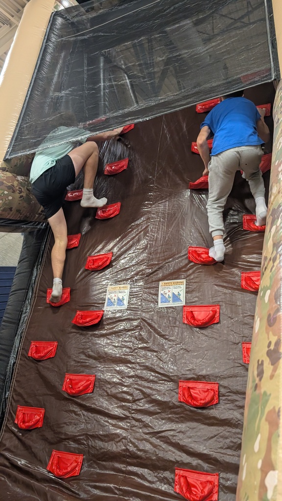 Students climbing the inflatable wall