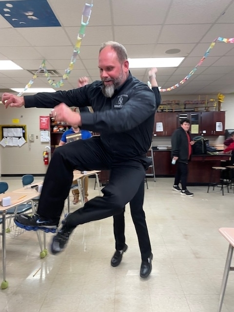 Coach Miles jumping for joy to celebrate the Regional Championship 