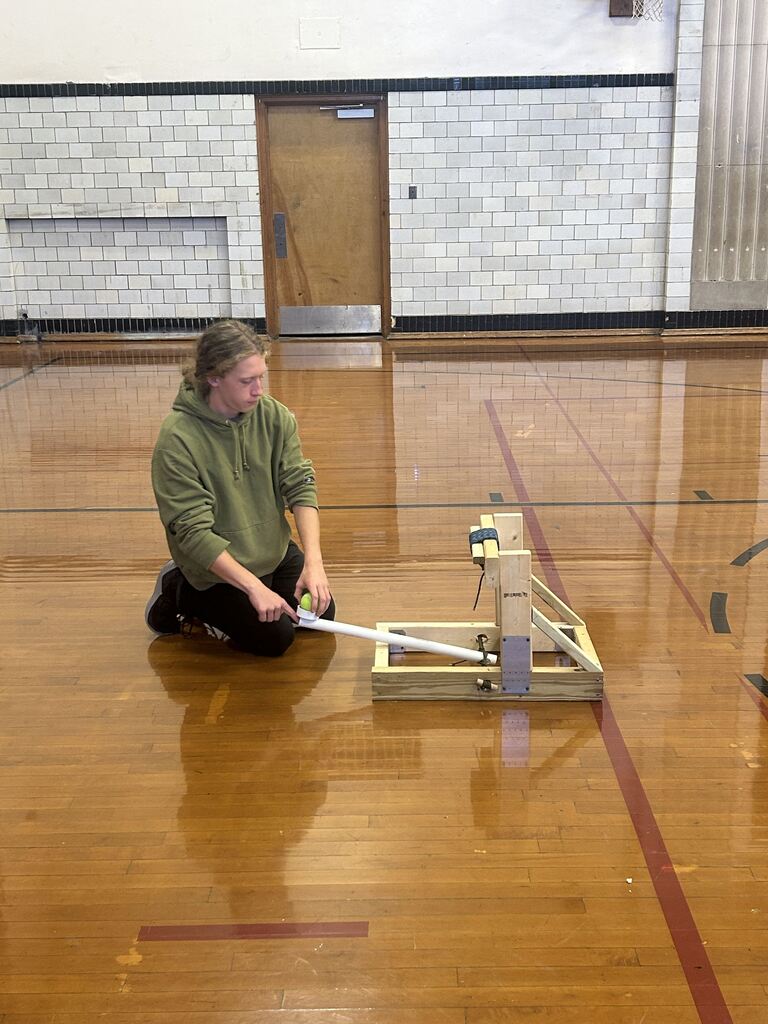 Elias Nolan preparing to launch his catapult. He partnered with Jacob Johnson. 