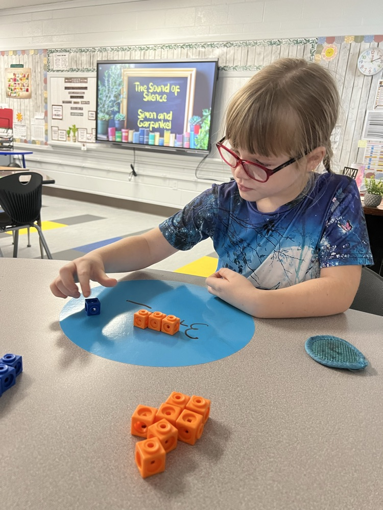 Adding with math link cubes and writing addition equations