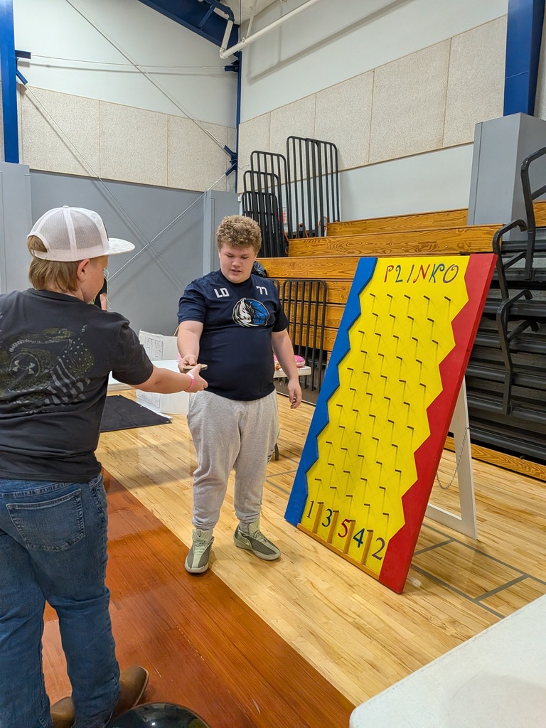 Donovan helps someone play Plinko