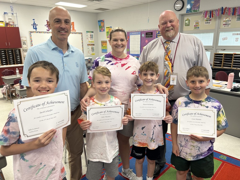 four students holding perfect test score certificates with Superintendent, Mrs. Racz, Mr. Cardillo