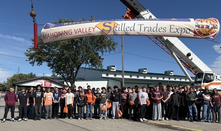 Boardman students in front of a crane at the skilled trades expo in Canfield