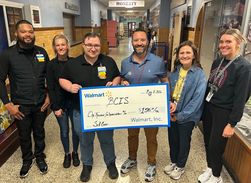 3 walmart representatives present $1,500 check for BCIS to principal DeAngelo, and counselors