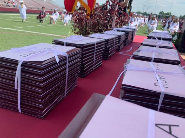 Diplomas wrapped in ribbon on table