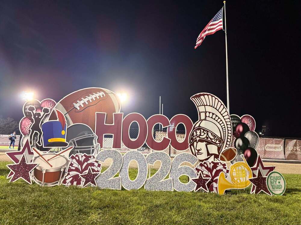 Boardman Spartan Homecoming 2026 Yard Sign in front of the field with the flag