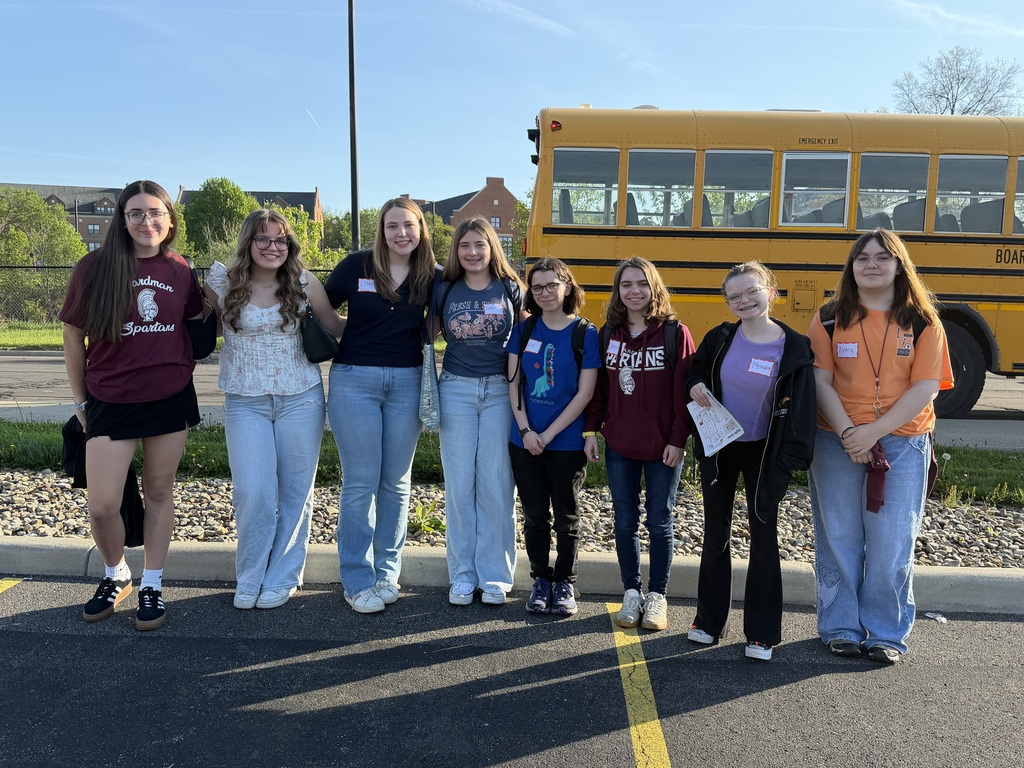 9th grade students standing in front of school bus headed to YSU English Festival