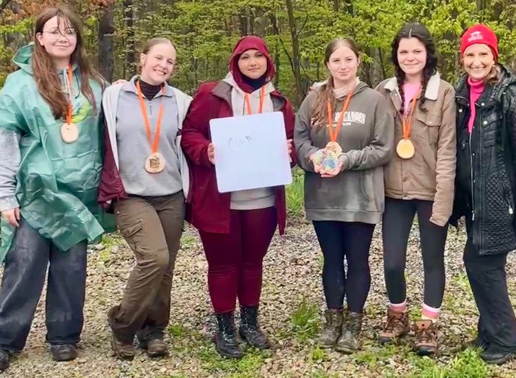 5 students wearing medals with BHS AP enviro teacher Heather Moran