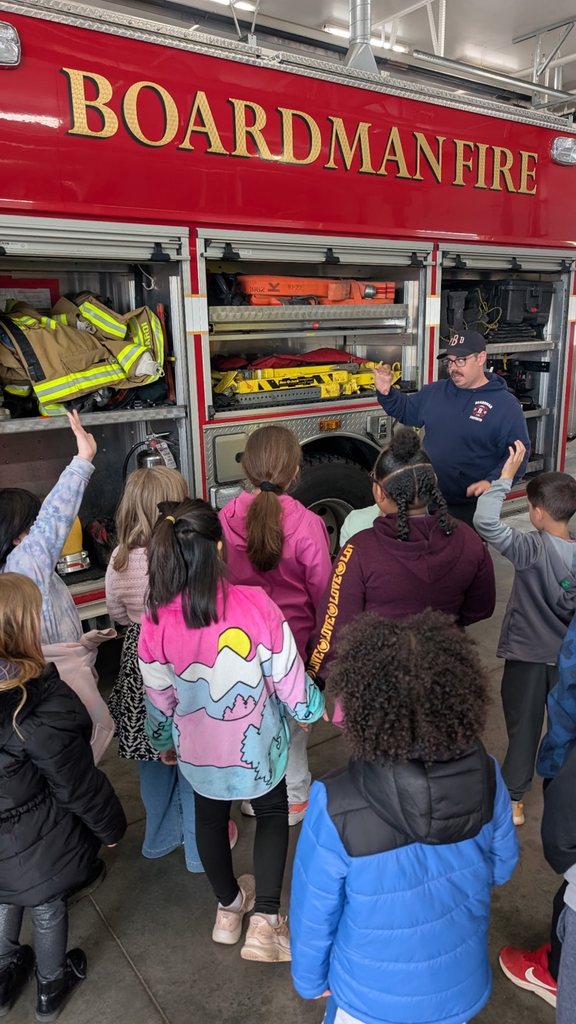 students looking at tools on the fire truck