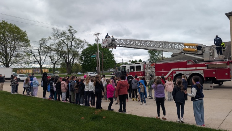 students outside with the huge ladder truck