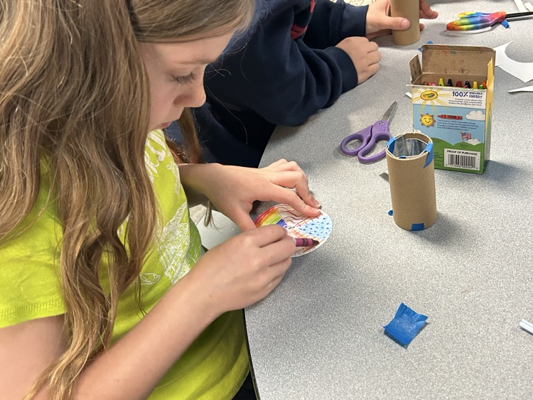 girl coloring her circle to put in the kolaidescope
