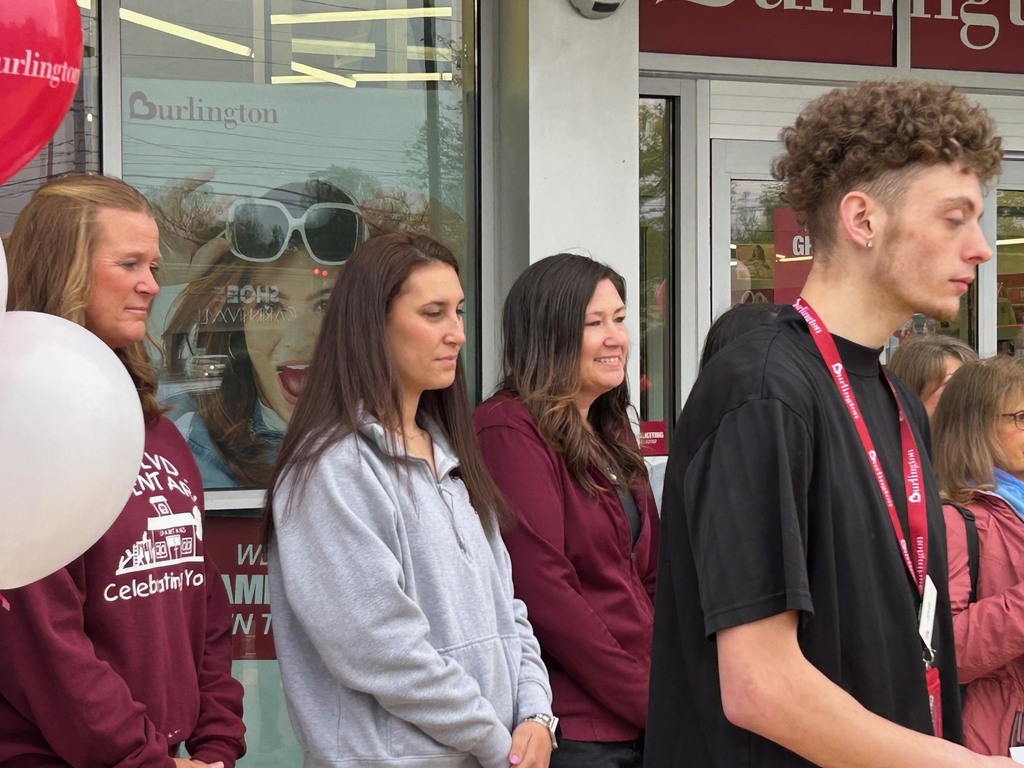 three teachers listening  during  the ribbon cutting at Burlington 