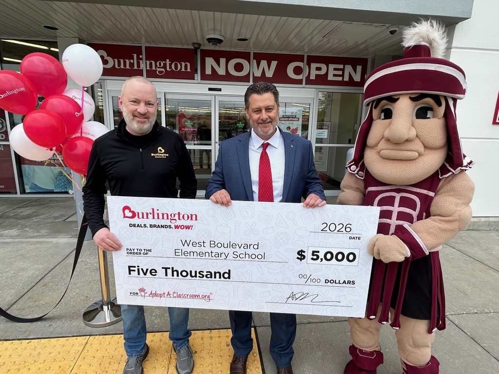 Burlington manager and principal cervello holding $5K check with sparty 