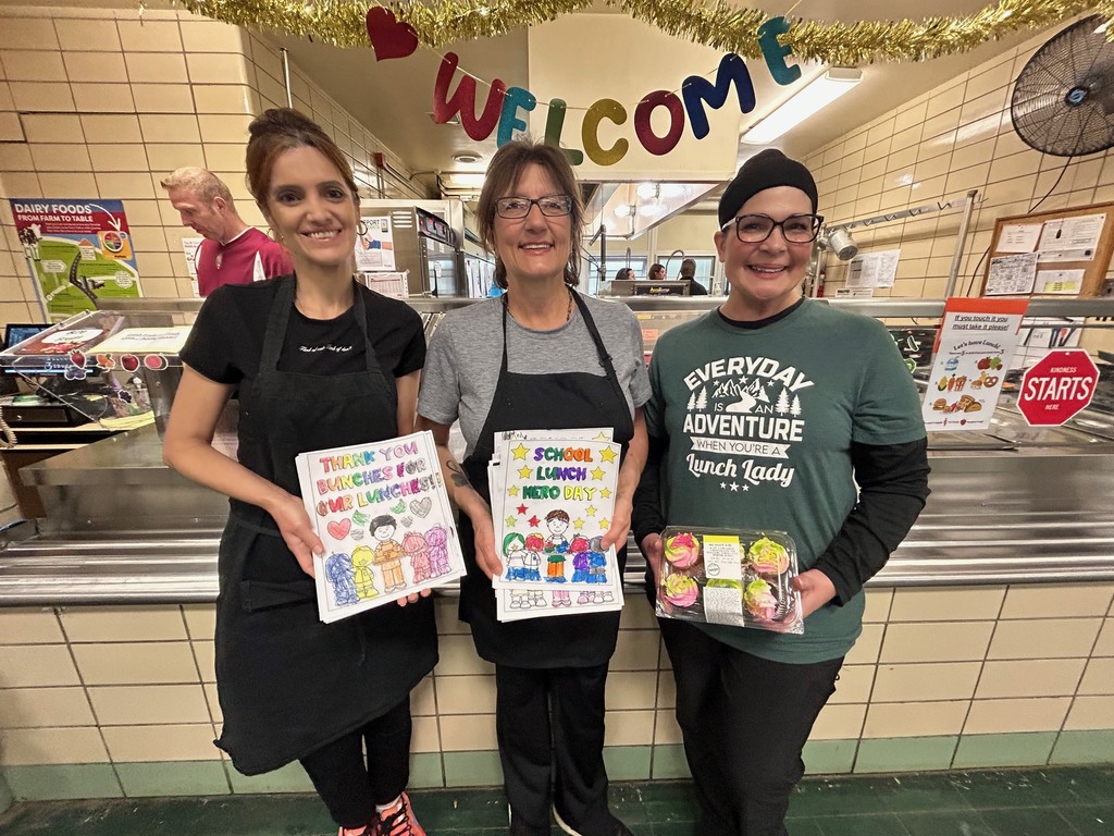 three lunch ladies at Robinwood with thank you posters from kids