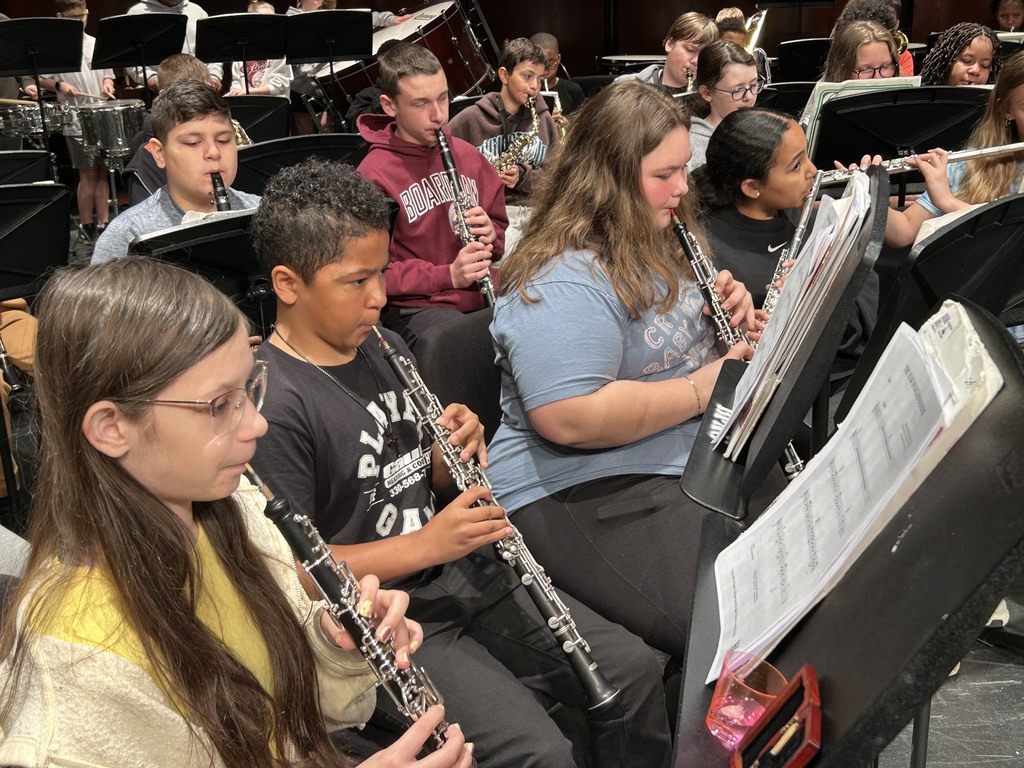students playing clarinets on stage