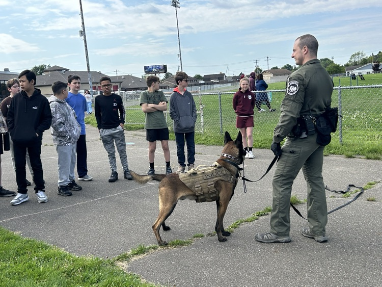 police K-9 unit with students listening to handler