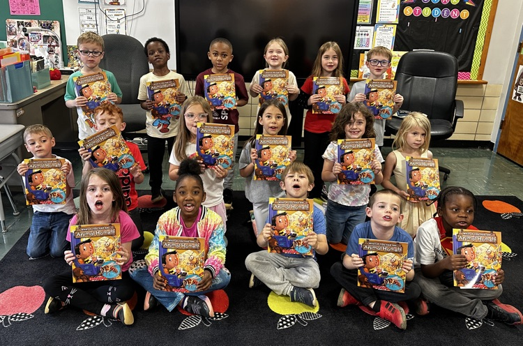 Mrs.Bennett’s kindergarteners holding their new books donated by Kiwanis 