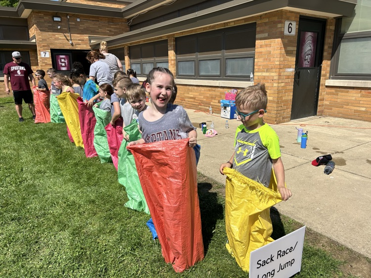 sack races with girl smiling