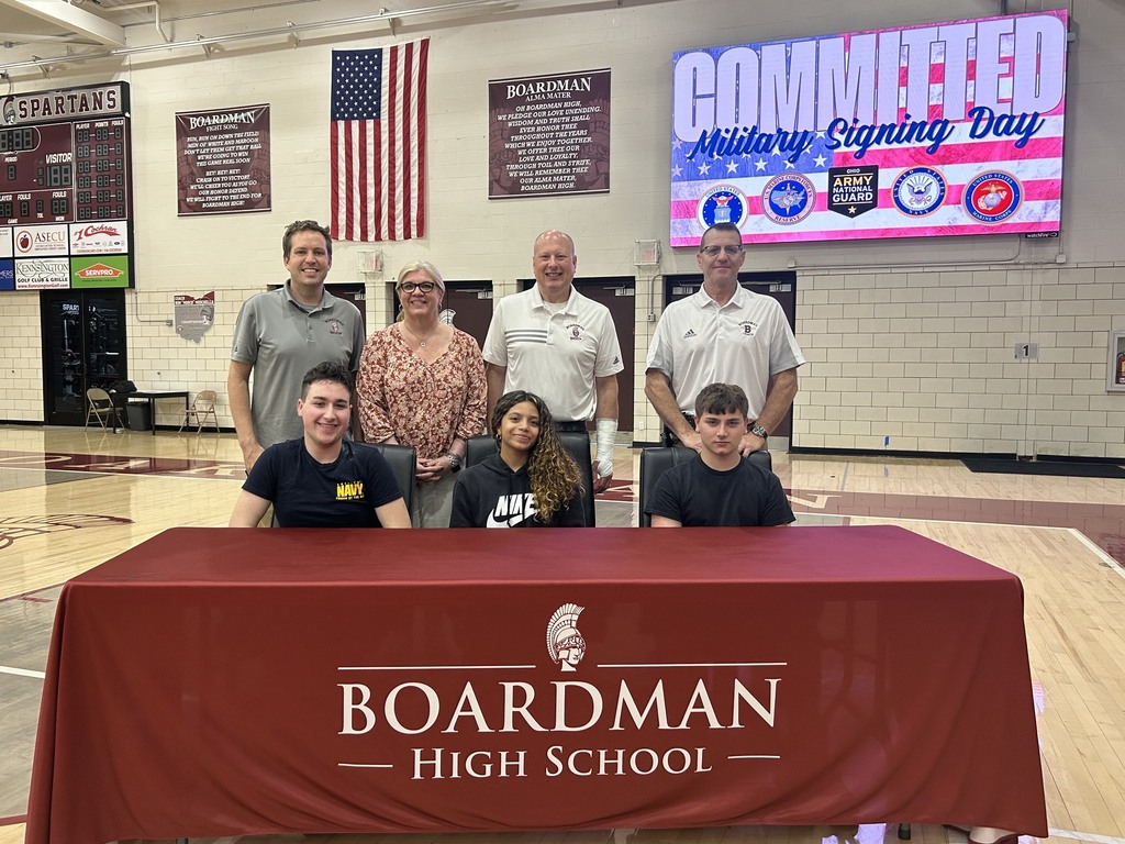 Chase, Carmen and Jeffery with BHS principals standing behind them at the military signing table