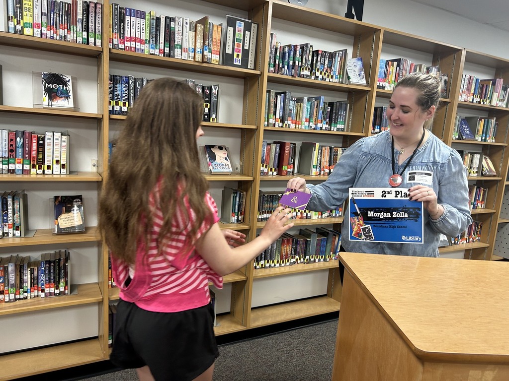Librarian giving gift card and certificate to Morgan Zolla