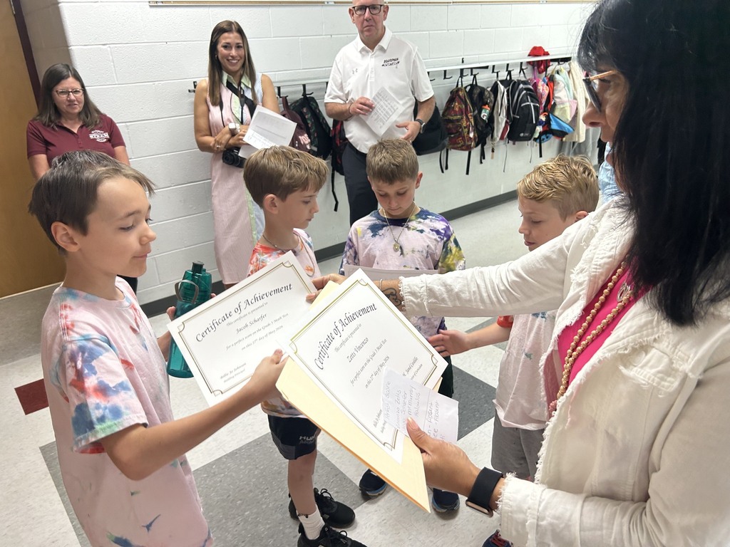 Principal Johnson handing out perfect score certificates