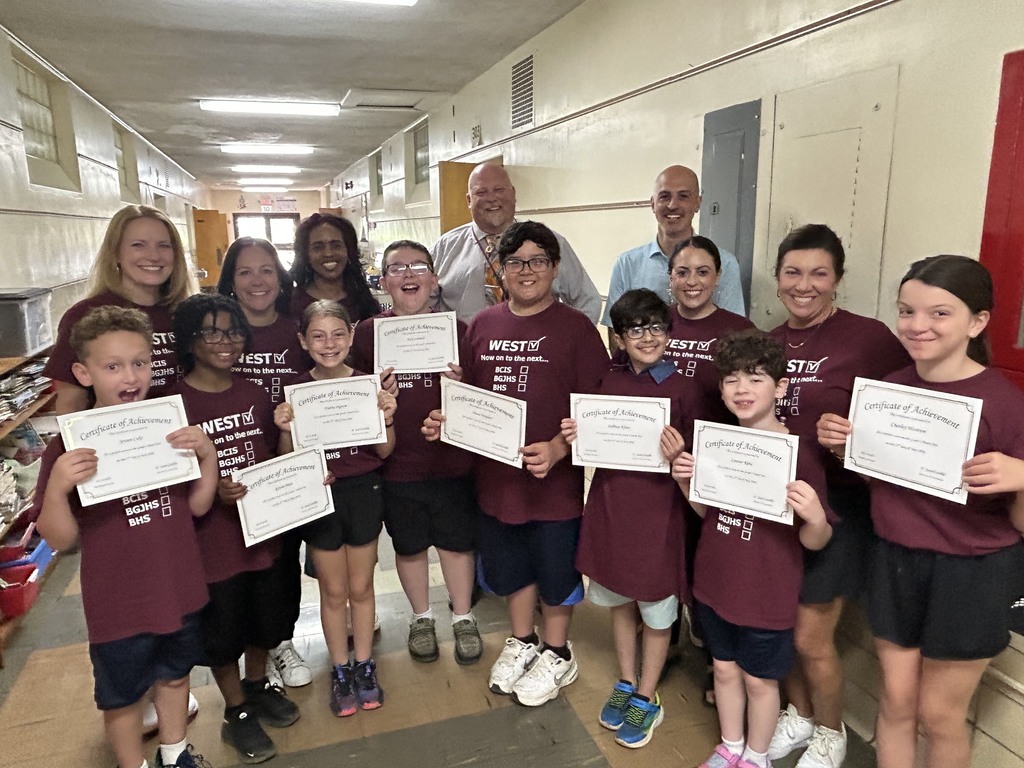 8 3rd graders holding perfect score certificates with teachers, superintendent and Mr. Cardillo